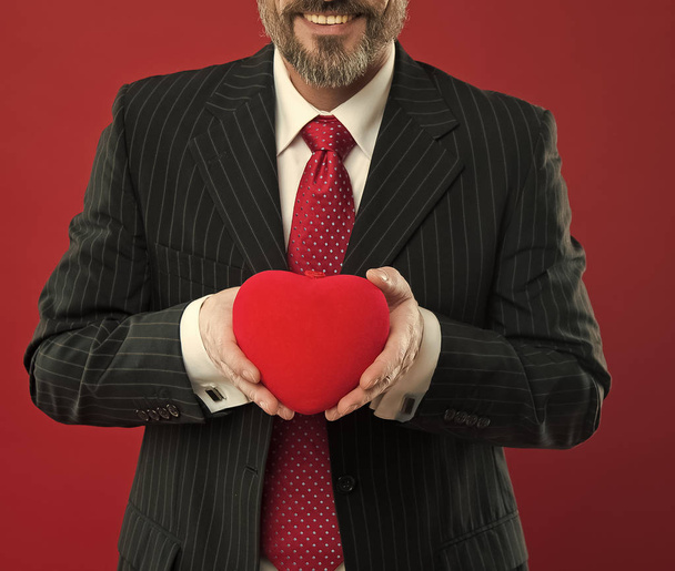 All my love is for you. diseased heart. Love and romance health care. mature man hold valentines heart. February holiday. Happy man with big red heart. businessman in suit. success and fortune - Фото, изображение