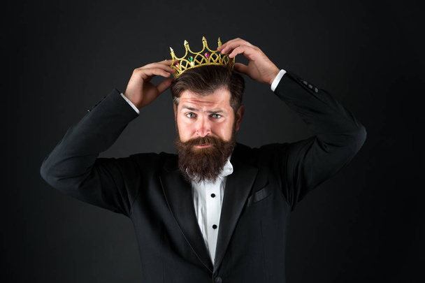 Sense of self importance. Big boss. King crown. Egoist concept. Businessman in tailored tuxedo and crown. Very important person. Important guest luxury party. Top manager. Important person award - Фото, изображение
