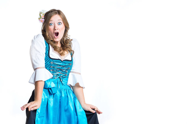shocked young woman in traditional bavarian costume dirndl looking at camera isolated on white - Photo, Image