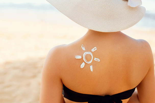 Femme avec crème solaire en forme de soleil
 - Photo, image