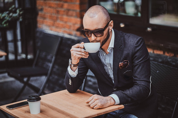 Attractive groomed man is enjoying coffee - Fotó, kép