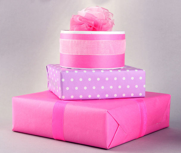 Bright gifts with bows on grey background - Foto, Bild