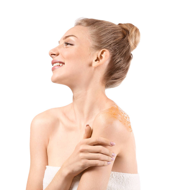 Young woman with orange body scrub on her body against white background - Foto, Bild