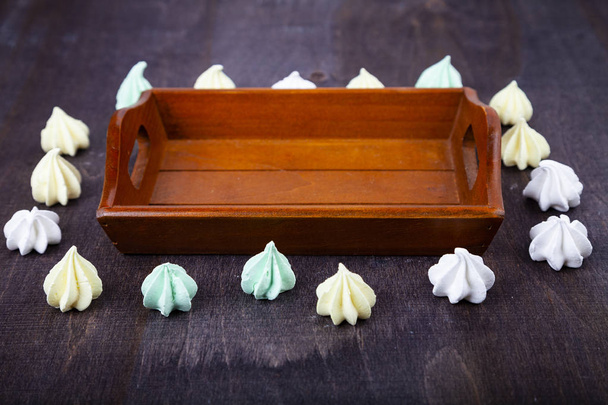 Meringue and a wooden tray  - Photo, image