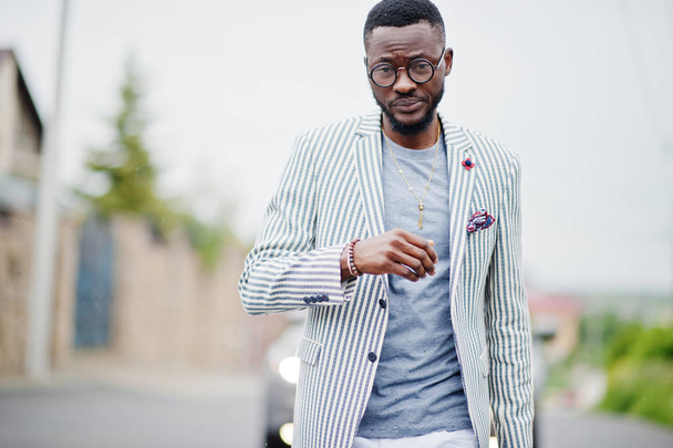 Rich and stylish african american man in blazer and white pants, - Фото, изображение