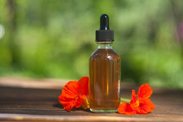 nasturtium essential oil in  beautiful bottle on wooden backgrou - Photo, Image