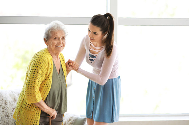 Caregiver with senior woman in nursing home - Photo, Image
