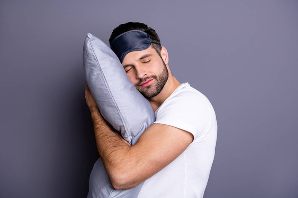 Close-up portrait of his he nice attractive bearded guy holding in hands pillow drowsiness going to bed sleeping quietly calmly isolated over gray pastel violet purple background - Zdjęcie, obraz