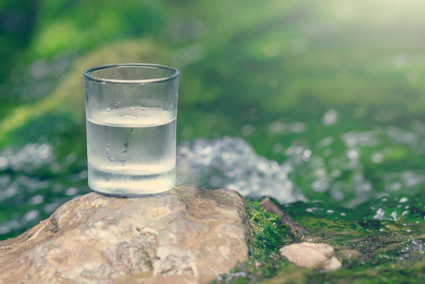 The glass of cool fresh water on nature background - Photo, Image