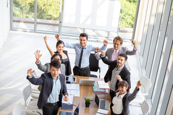 Successful startup entrepreneurs and business people team achieving goals celebrating giving high five in office. Success and winning concept - 写真・画像