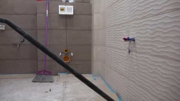 bathroom room hoovering with vacuum cleaner after construction works - Footage, Video