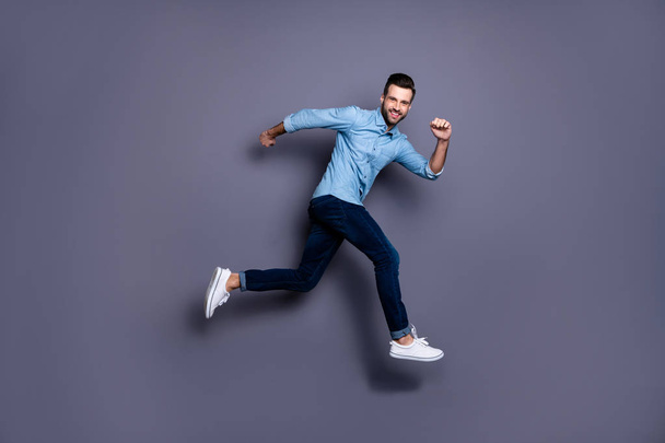 Full length body size view portrait of his he nice cool perfect strong content cheerful cheery macho guy running activity marathon isolated over gray violet purple pastel background - Fotografie, Obrázek