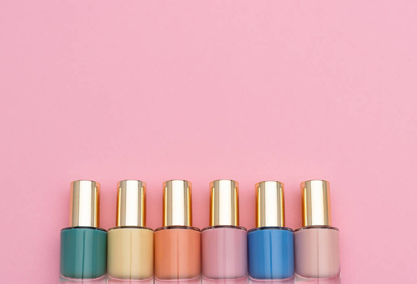 Row of pastel nail polishes near blank space - Foto, Imagen