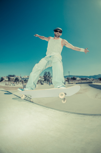 Skateboarder in a concrete pool - Фото, изображение