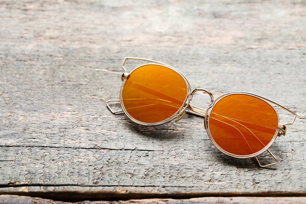 Fashion sunglasses on grey wooden table - Photo, Image