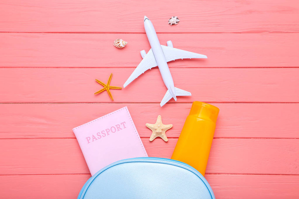 Seashells with passport, sunscreen and airplane model on wooden  - Φωτογραφία, εικόνα