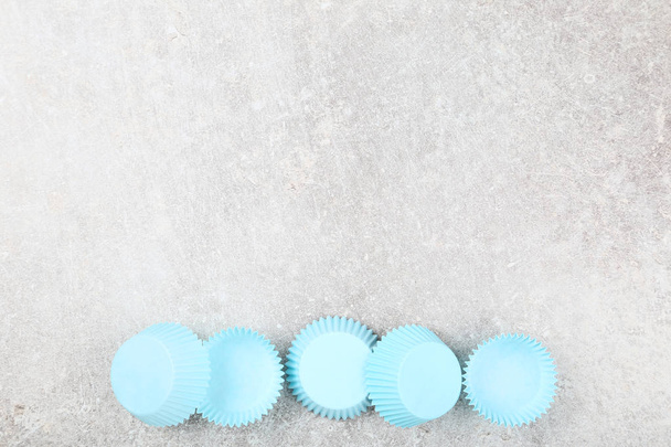 Cupcake cases on grey background - Fotografie, Obrázek