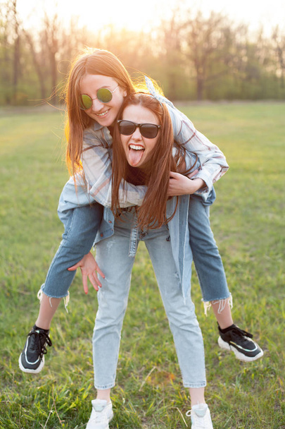 Two young women having fun outdoors. Best friends - Fotoğraf, Görsel
