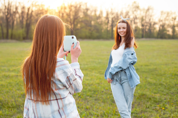One girl shooting another on camera. Best friends - Valokuva, kuva