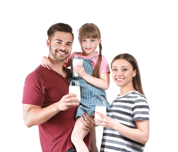 Young family with glasses of tasty milk on white background - Fotoğraf, Görsel