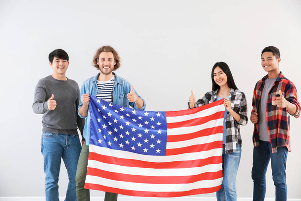 Group of students with USA flag on light background - Photo, Image