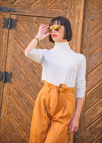 Fashionable outfit slim tall lady. Woman walk in elegant outfit. Fashion and style concept. Woman fashionable brunette stand outdoors wooden background. Girl with makeup posing in fashionable clothes - Zdjęcie, obraz