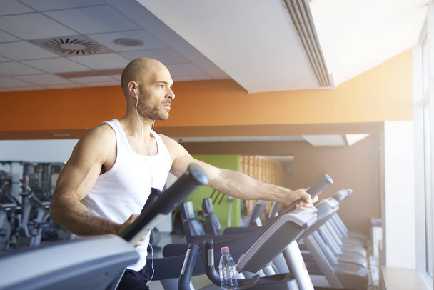 Man doing cardio training on treadmill  - Фото, зображення