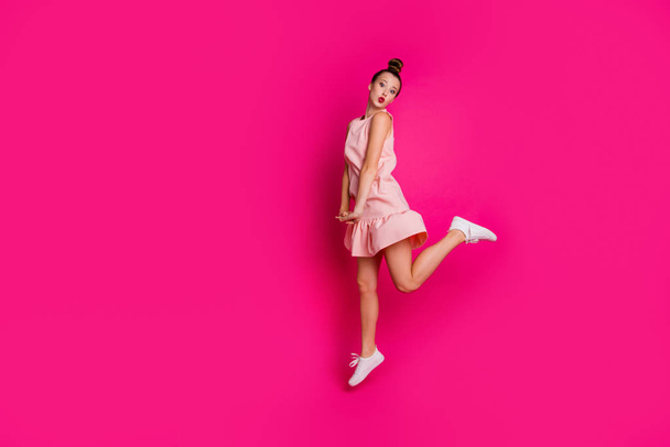 Full length body size view photo of lovely sweet attractive lady have free time dressed top-knot pomade lipstick red active motion movement legs sneakers isolated pink background - Foto, afbeelding