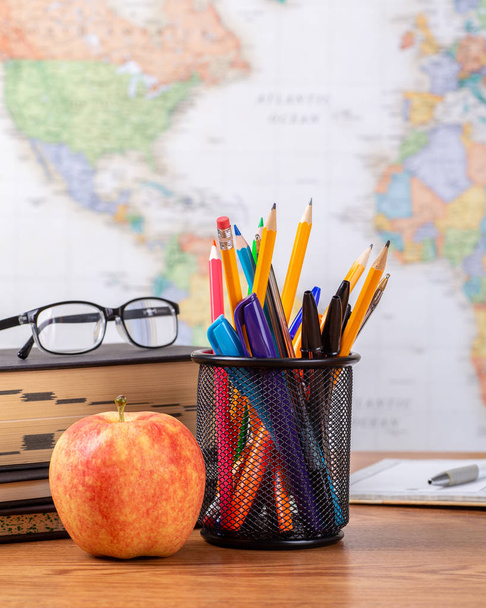 School Teachers Desk With World Map in Background - Фото, изображение
