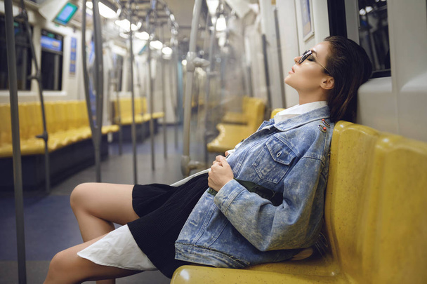 Sexy model is posing in carriage of metro train - 写真・画像