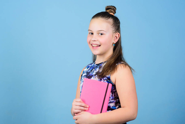 small girl with pink note book. school child with notepad. Smart and adorable. schoolgirl ready for lesson. school diaries for making note. love reading book. workbooks for writing. student read book - Foto, Imagem