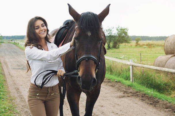 Young woman rider and her beautiful horse - Photo, image
