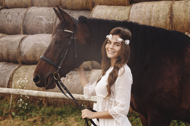 Cute young woman and her beautiful horse - Photo, image
