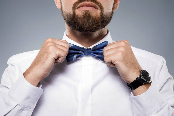 Man is fiting up a beautiful bow tie  - Foto, Bild