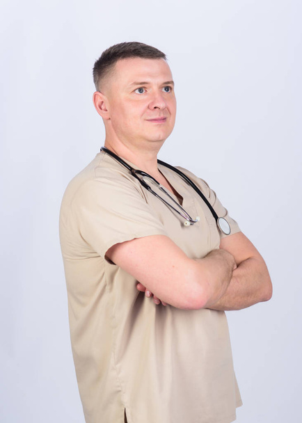 Treatment and prevention. Guy experienced doctor beige clothes on white background. Private clinic. Check health. Doctor career. Man doctor stethoscope physician uniform. Medicine and health care - Φωτογραφία, εικόνα