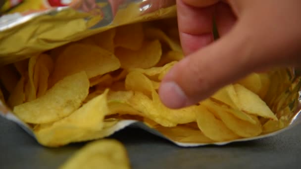 Hand taking potato chips - Felvétel, videó