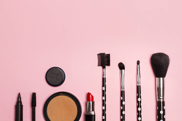 Rouge, Pinsel und Lippenstift zum Make-up auf rosa Hintergrund - Foto, Bild