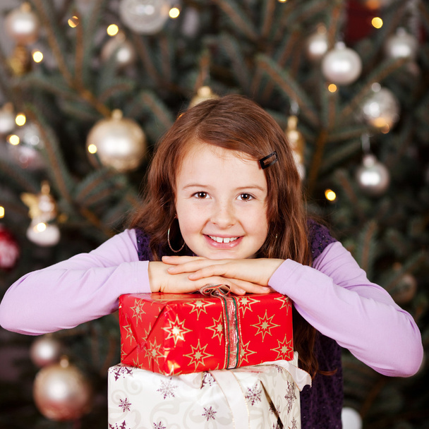 Pretty happy girl with her Christmas gifts - Fotoğraf, Görsel