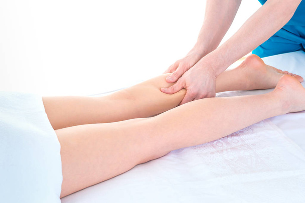 Detail of hands massaging human calf muscle.Therapist applying p - Foto, Imagem