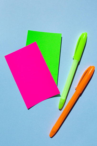 Neon colorful sticky note paper and pen on blue background.  - Fotoğraf, Görsel