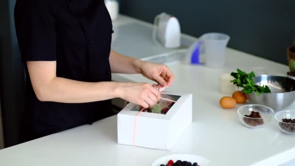 Baker puts cupcakes into the box, beautiful and delicious food, cooking and baking in the kitchen - Footage, Video