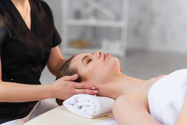 Handsome caucasian woman during spa treatment in the spa salon. - Foto, imagen