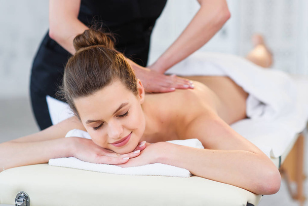 Beautiful caucasian woman during massage in spa salon. - Fotografie, Obrázek