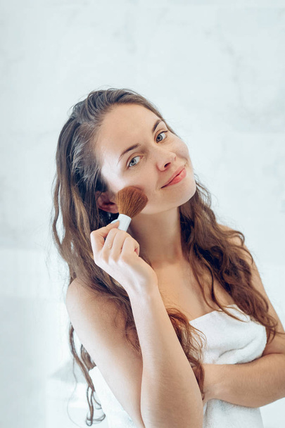 Beautiful girl with cosmetic powder brush for make up. Makeup. Make-up applying  for perfect skin. - Fotografie, Obrázek
