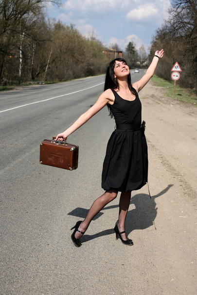 Hitch-hike girl with vintage suitcase - Photo, Image