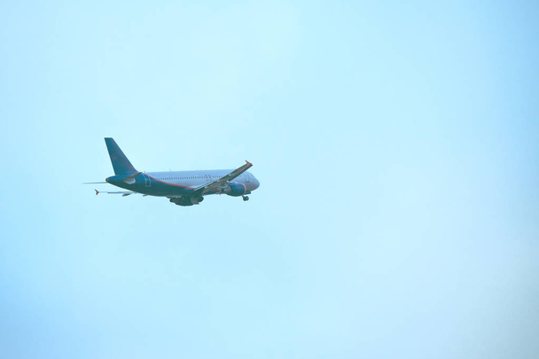takeoff of a passenger liner against a blue sky, toned - Fotoğraf, Görsel