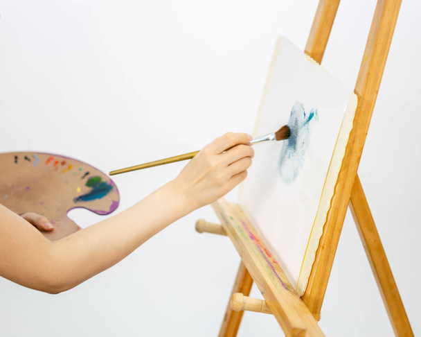 Artist painting oil painting on an easel - 写真・画像