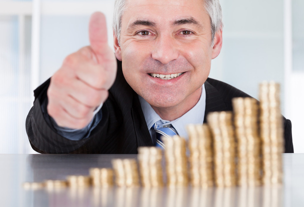 Businessman With Coins Showing Thumbs Up Sign - Foto, Imagen