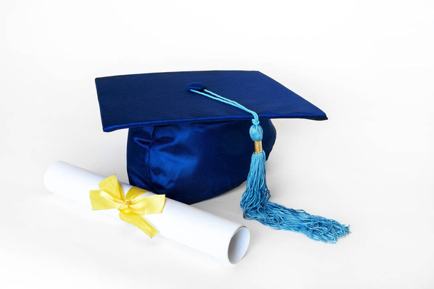 Μπλε καπάκι αποφοίτησης με δίπλωμα απομονωμένο σε λευκό φόντο - Φωτογραφία, εικόνα