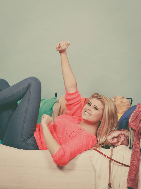 Woman does not know what to wear lying on couch - Photo, Image